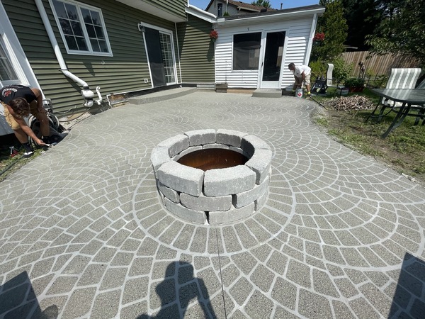 A fire pit on a concrete patio.