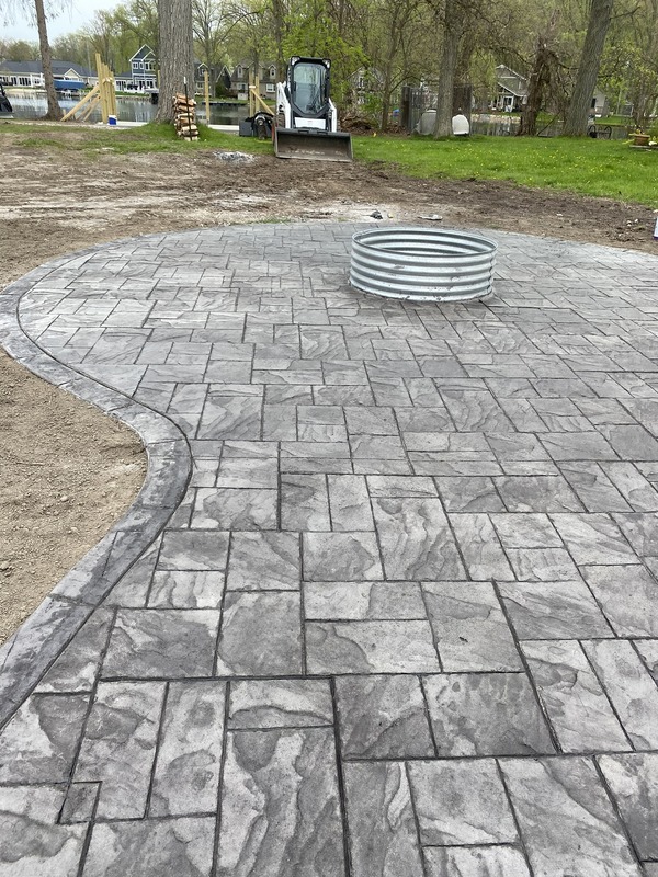 A fire pit on a concrete patio.