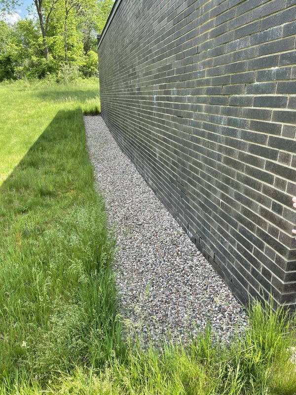 A french drain next to a building.