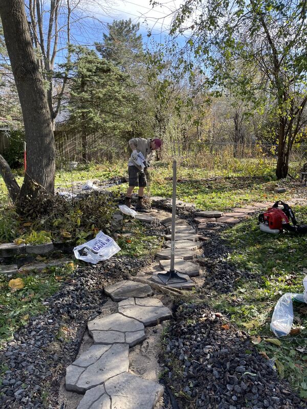 A stone walking path being installed.