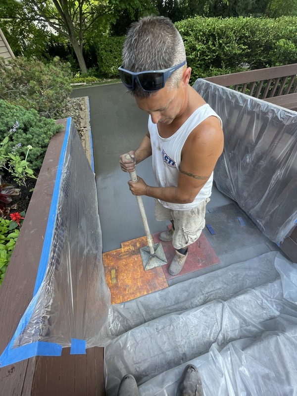 A stamped concrete patio being installed.